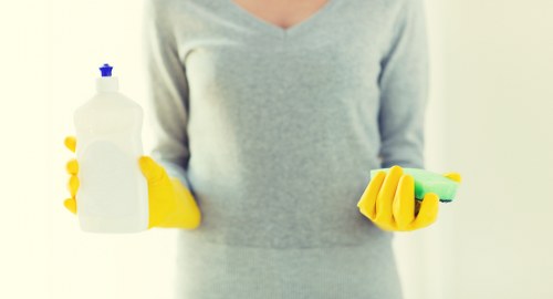 Technician carrying out a careful carpet cleaning job with safety measures in place